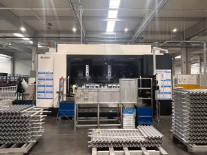 Engineer working on dual-channel CNC machine; close-up of probe system or aluminum extrusions