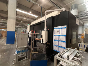 Engineer working on dual-channel CNC machine; close-up of probe system or aluminum extrusions 1